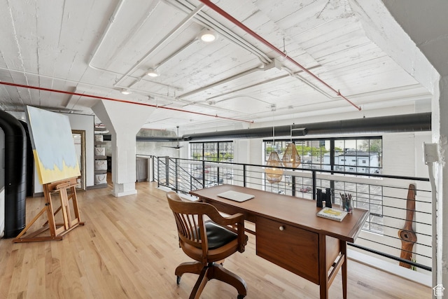 home office featuring plenty of natural light and wood finished floors