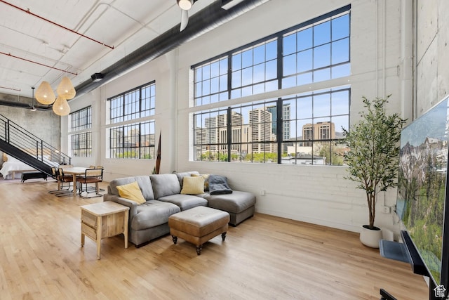 community lobby with a towering ceiling, stairway, and a city view