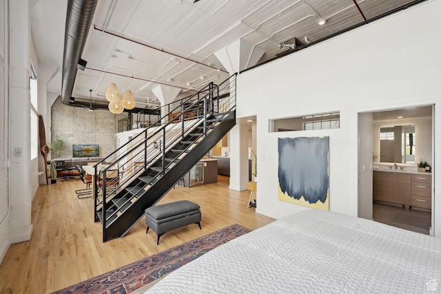 living room featuring stairs, wood finished floors, and a high ceiling