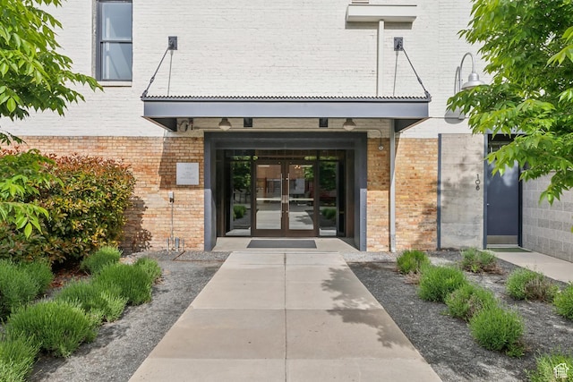 doorway to property with french doors and brick siding