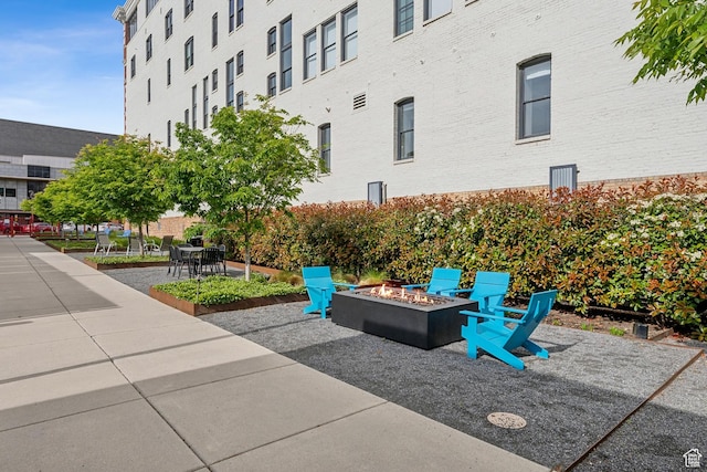 view of property's community featuring a fire pit and a patio area