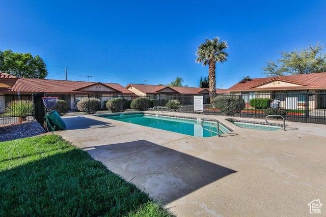 community pool featuring a patio and fence