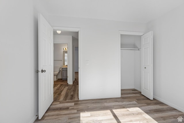 1075 N 1400 W Unit 32, St George, UT 84770 - unfurnished bedroom with wood finished floors, a closet, and baseboards