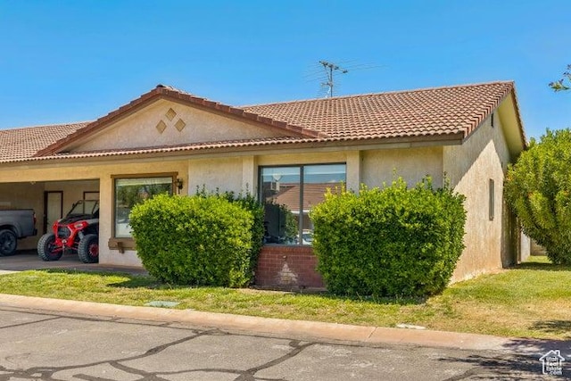 1075 N 1400 W Unit 32, St George, UT 84770 - view of front of house with stucco siding and a carport