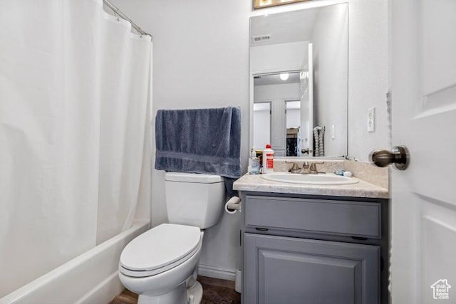 bathroom featuring vanity, toilet, and shower / tub combo