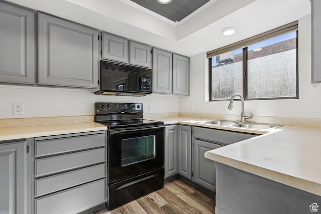 1075 N 1400 W Unit 32, St George, UT 84770 - kitchen with black appliances, gray cabinetry, a sink, dark wood finished floors, and light countertops