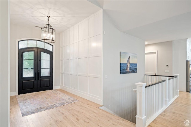 684 S 990 W, Hurricane, UT 84737 - entryway featuring a chandelier, light wood-style floors, french doors, a decorative wall, and baseboards