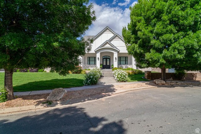 684 S 990 W, Hurricane, UT 84737 - tudor home with covered porch, a front yard, stucco siding, and french doors