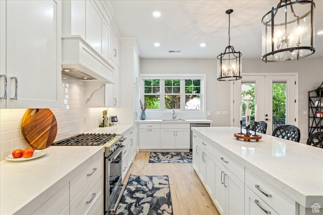 684 S 990 W, Hurricane, UT 84737 - kitchen featuring stainless steel appliances, a sink, a chandelier, light wood-style flooring, and plenty of natural light