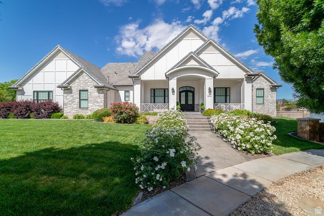 684 S 990 W, Hurricane, UT 84737 - view of front of property featuring covered porch, a front yard, stone siding, french doors, and stucco siding