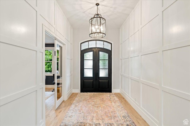 684 S 990 W, Hurricane, UT 84737 - entrance foyer with french doors, light wood-type flooring, a chandelier, and a decorative wall