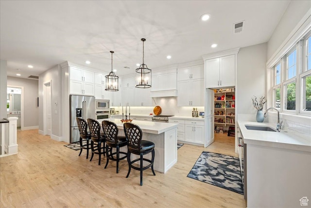 684 S 990 W, Hurricane, UT 84737 - kitchen featuring a sink, appliances with stainless steel finishes, backsplash, a breakfast bar area, and recessed lighting