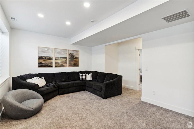 living area featuring light carpet, recessed lighting, and baseboards