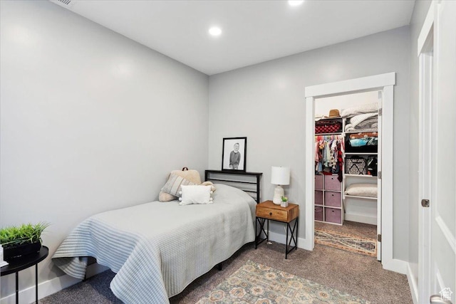 carpeted bedroom with a walk in closet, a closet, baseboards, and recessed lighting