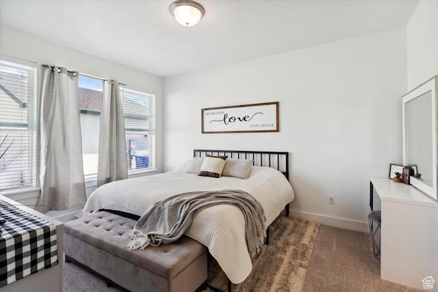 carpeted bedroom featuring baseboards