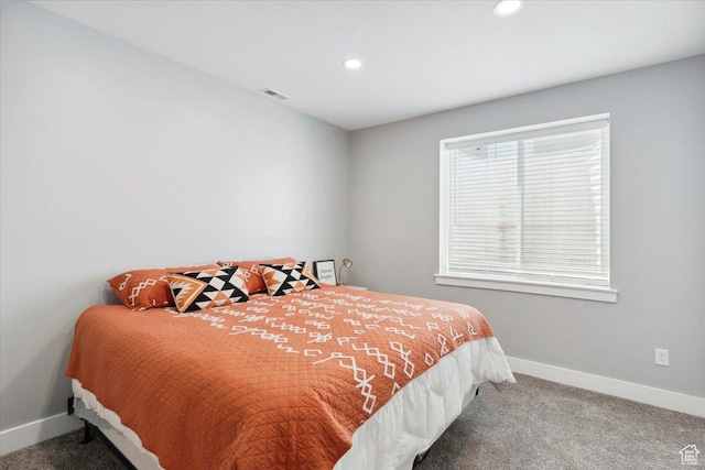 carpeted bedroom featuring baseboards and recessed lighting