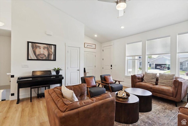 living room with lofted ceiling, light wood-style floors, a ceiling fan, recessed lighting, and baseboards