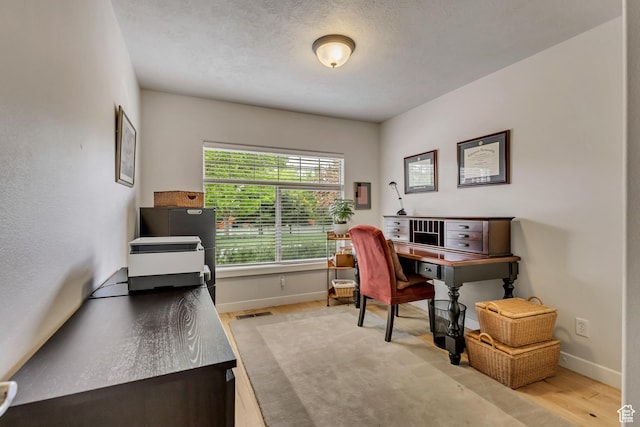 home office with wood finished floors and baseboards