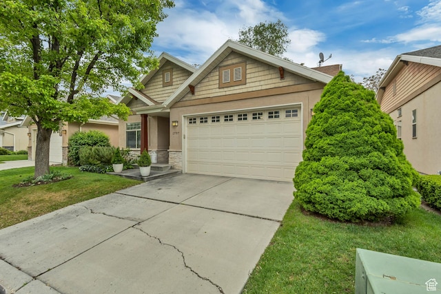 view of front facade with stone siding, concrete driveway, a garage, a front yard, and stucco siding