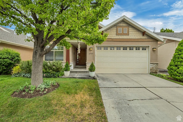 view of front of property featuring a garage, stucco siding, stone siding, driveway, and a front yard