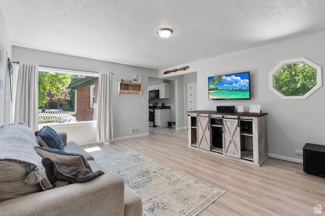 living area featuring light wood-type flooring and baseboards