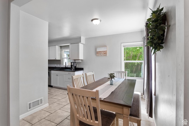 dining room featuring plenty of natural light and light tile patterned floors