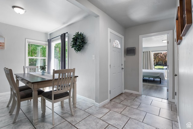 dining space featuring baseboards and light tile patterned floors