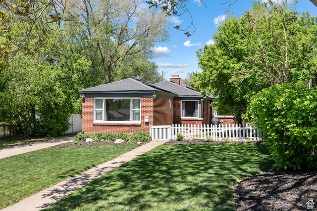 view of front of house featuring brick siding and a chimney