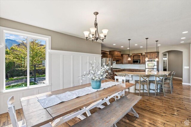 916 Country Ln, Farmington, UT 84025 - dining room featuring arched walkways, a chandelier, recessed lighting, and dark wood-type flooring