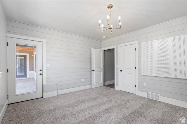 916 Country Ln, Farmington, UT 84025 - carpeted spare room with wooden walls and a chandelier