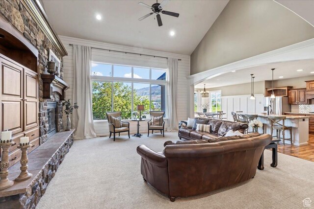 916 Country Ln, Farmington, UT 84025 - living room with high vaulted ceiling, arched walkways, ceiling fan, a stone fireplace, and recessed lighting