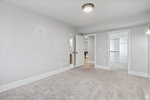 916 Country Ln, Farmington, UT 84025 - unfurnished bedroom featuring light carpet, baseboards, a closet, and a spacious closet