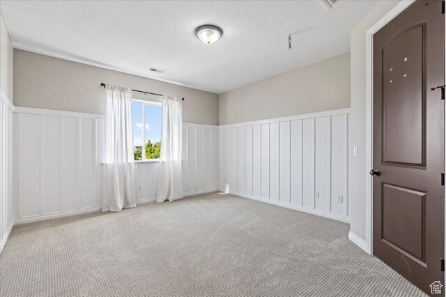 916 Country Ln, Farmington, UT 84025 - empty room with carpet, a wainscoted wall, and a decorative wall