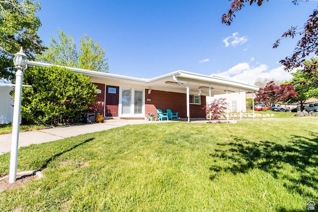 single story home with brick siding and a front lawn