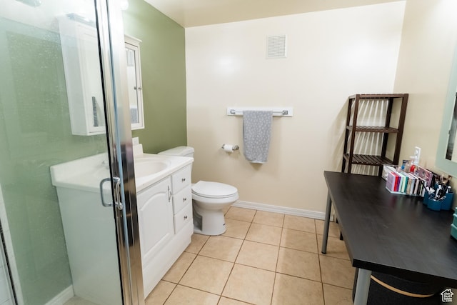 bathroom with vanity, tile patterned flooring, a stall shower, toilet, and baseboards