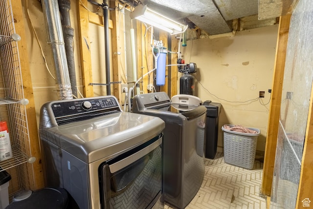 washroom with separate washer and dryer and brick patterned flooring