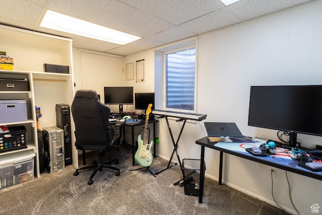 office space with a drop ceiling, carpet floors, and baseboards