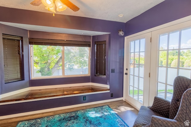 bathroom with baseboards, plenty of natural light, and wood finished floors