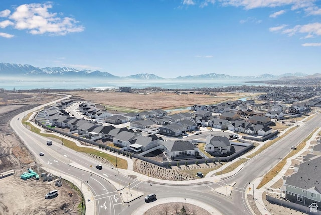 aerial view of residential area featuring a water and mountain view