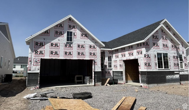 unfinished property with a garage and central AC