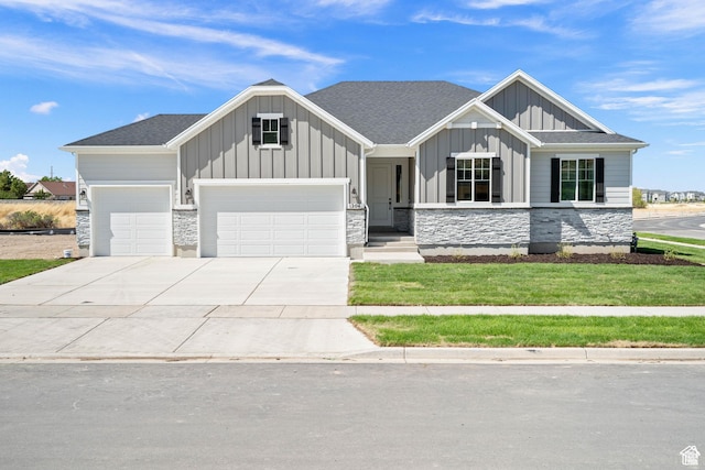 1147 S 3170 E Unit 207, Spanish Fork, UT 84660 - view of front of property featuring board and batten siding, an attached garage, stone siding, and driveway
