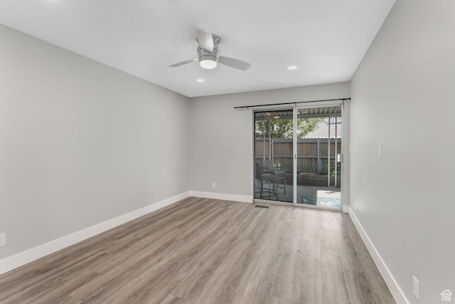 empty room featuring wood finished floors, ceiling fan, baseboards, and recessed lighting