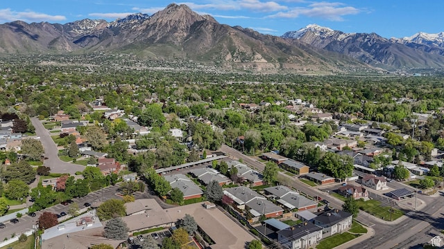 aerial overview of property's location with a mountain backdrop and nearby suburban area