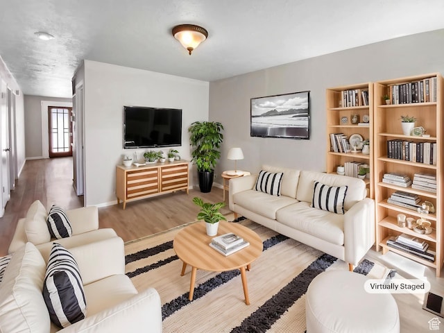 living room featuring wood finished floors and baseboards