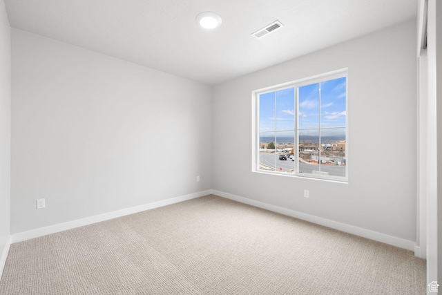 carpeted empty room featuring baseboards and recessed lighting