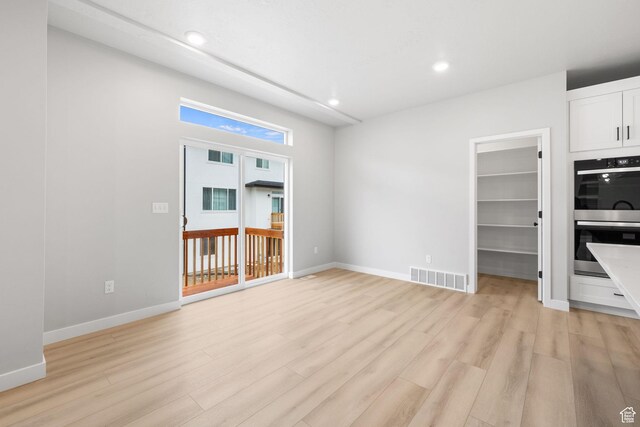 unfurnished living room featuring light wood-style flooring, recessed lighting, and baseboards