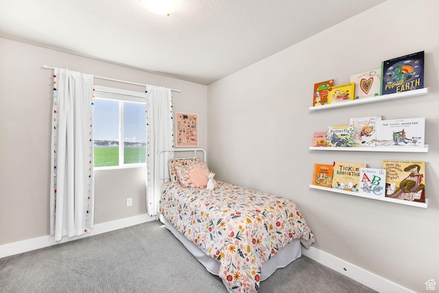 bedroom featuring baseboards and carpet flooring