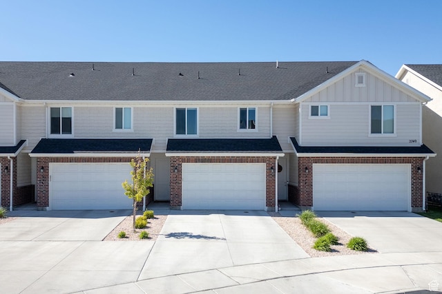 townhome / multi-family property with an attached garage and driveway