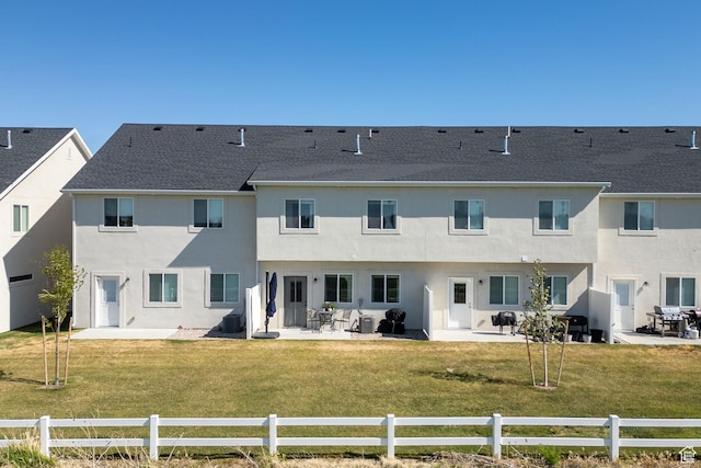 rear view of property featuring a patio area, stucco siding, central AC, and roof with shingles