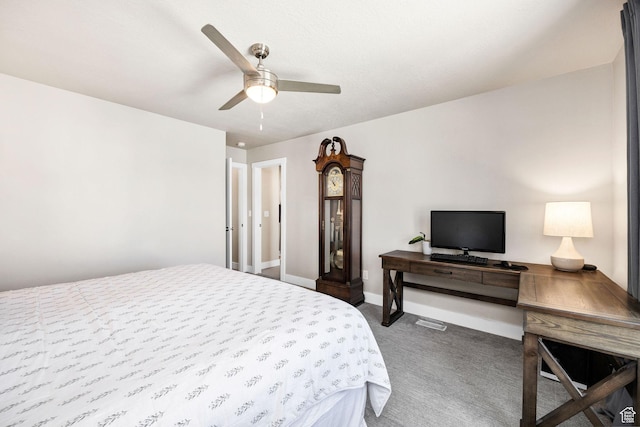 bedroom with dark carpet, baseboards, and a ceiling fan